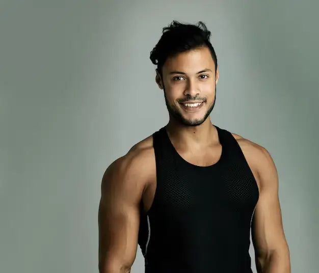 files/portrait-athlete-indian-man-with-tank-top-muscle-studio-health-wellness-gym-grey-background-strong-bodybuilder-smile-happy-male-person-ready-training-workout-fitness_590464-427883.webp